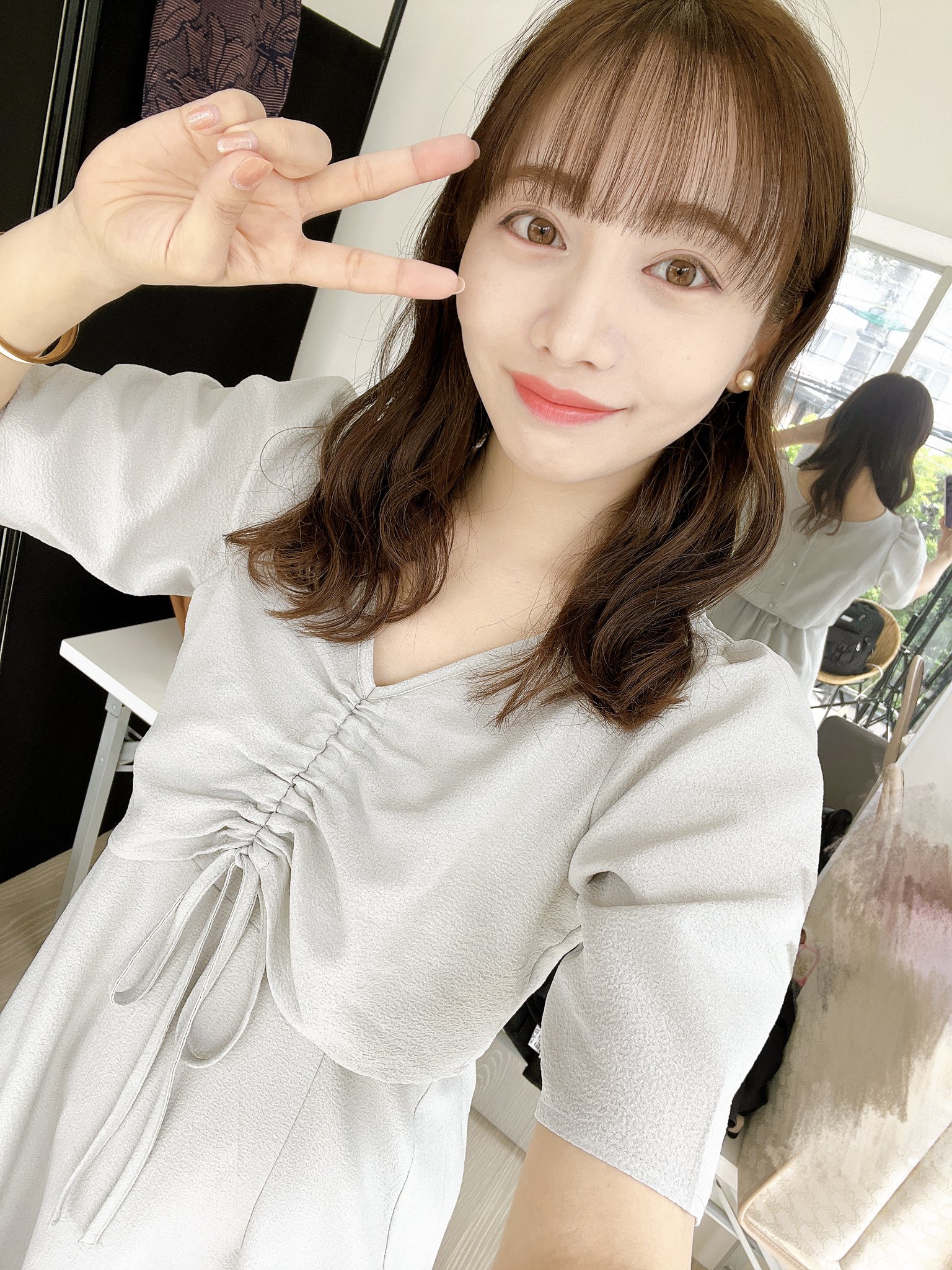 能條愛未が右手でピースをして顔に当てている